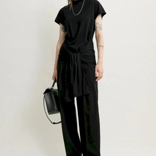 TOTEME Pre-Fall 2026
Uue hooaja võtmesiluetid ühendavad pehmuse ja täpsuse.
Tie-Waist Jersey Top on valmistatud lüotselli-puuvilla jersey’st ning tõlgendab klassikalist T-särki uues võtmes. Langev seotav vöödetail taljel, vabalt langevad õlad ja voolav siluett loovad pingevaba, kuid läbimõeldud terviku. Sidumata paelad toovad esile topi skulpturaalse iseloomu.
Koos Single Pleat Cotton pükstega, mille lai värvel, sügav esivolt ja pressitud viigijooned annavad modernse ning rafineeritud ilme, moodustub tasakaalustatud komplekt, mis kannab TOTEME-le omast vaikset enesekindlust.
Nüüd Maximalistis. TOTEME Pre-Fall 2026
Uue hooaja võtmesiluetid ühendavad pehmuse ja täpsuse.
Tie-Waist Jersey Top on valmistatud lüotselli-puuvilla jersey’st ning tõlgendab klassikalist T-särki uues võtmes. Langev seotav vöödetail taljel, vabalt langevad õlad ja voolav siluett loovad pingevaba, kuid läbimõeldud terviku. Sidumata paelad toovad esile topi skulpturaalse iseloomu.
Koos Single Pleat Cotton pükstega, mille lai värvel, sügav esivolt ja pressitud viigijooned annavad modernse ning rafineeritud ilme, moodustub tasakaalustatud komplekt, mis kannab TOTEME-le omast vaikset enesekindlust.
Nüüd Maximalistis.